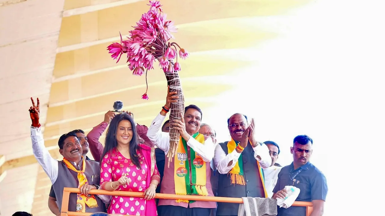 Devendra Fadnavis with his wife Amruta Fadnavis during a roadshow, in Nagpur, Sunday, Dec. 15, 2024.
