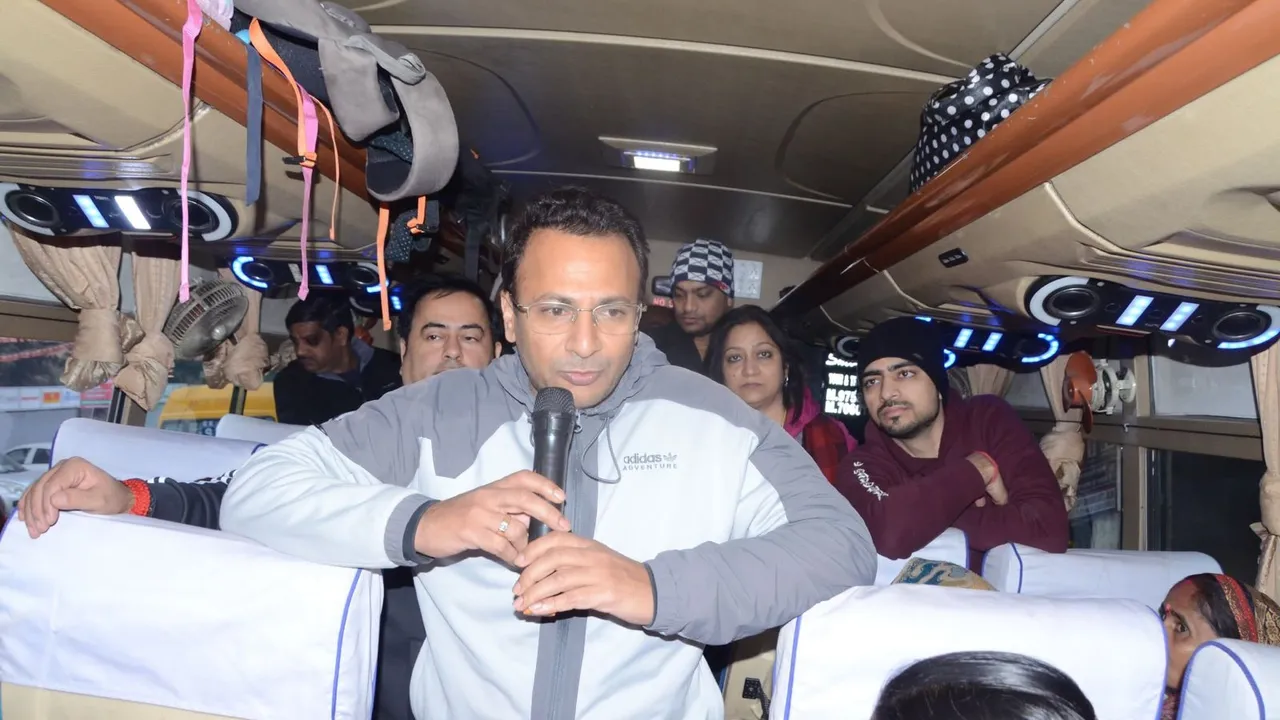 Vishnu Mittal flags off a bus to Vrindavan on Monday, December 16, 2024.