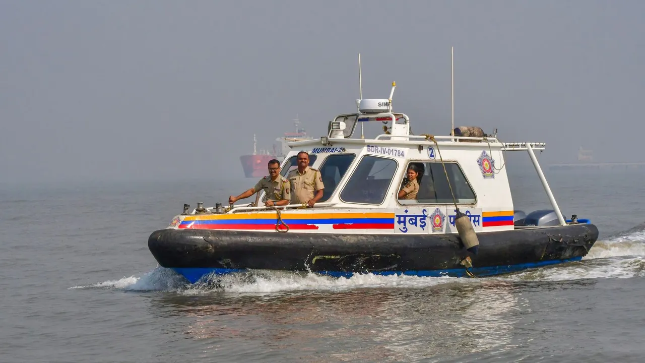 Security personnel during a search operation for missing passengers, two days after a ferry-Navy craft collision, in Mumbai