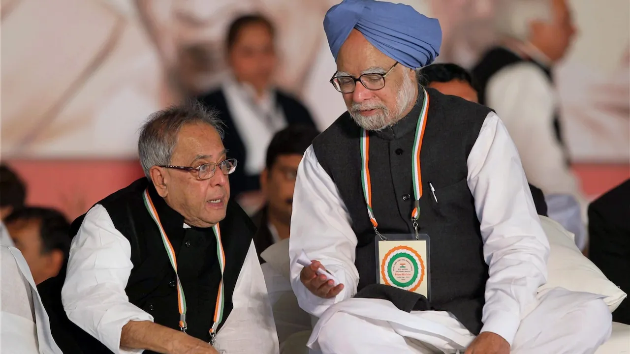 In this Dec. 20, 2010 file image, Prime Minister Manmohan Singh speaks to Finance Minister Pranab Mukherjee at the 83rd Plenary Session of Indian National Congress in New Delhi.