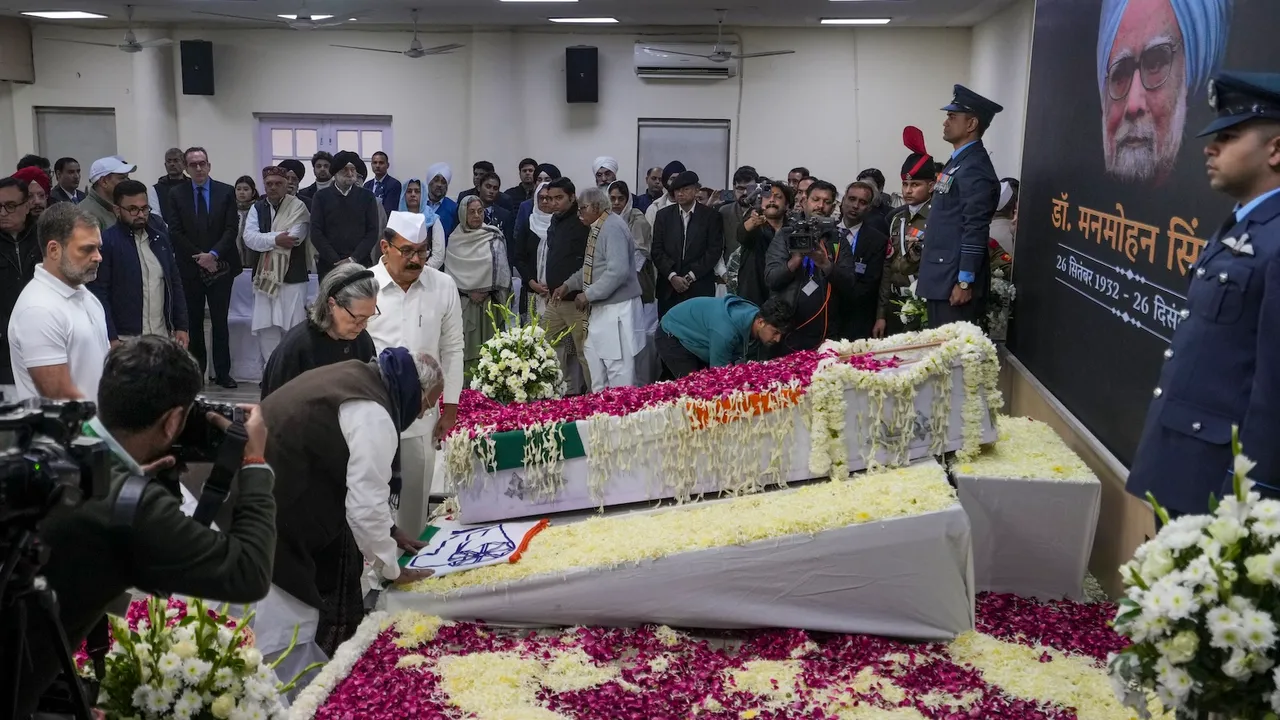 Mallikarjun Kharge and Sonia Gandhi pay their last respects to former prime minister Manmohan Singh, at AICC headquarters in New Delhi on Saturday, Dec. 28, 2024.