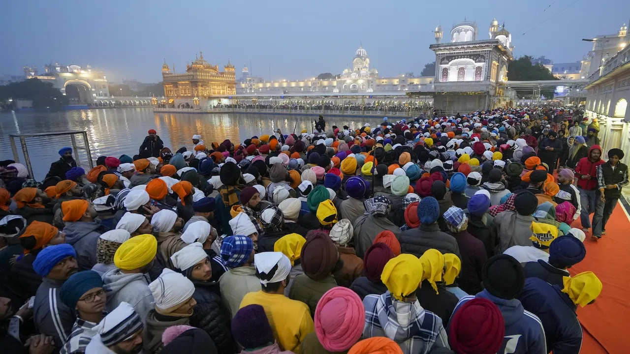 Devotees arrive to pay obeisance at the Golden Temple on the first day of new year 2025 in Amritsar on Wednesday, Jan. 1, 2025