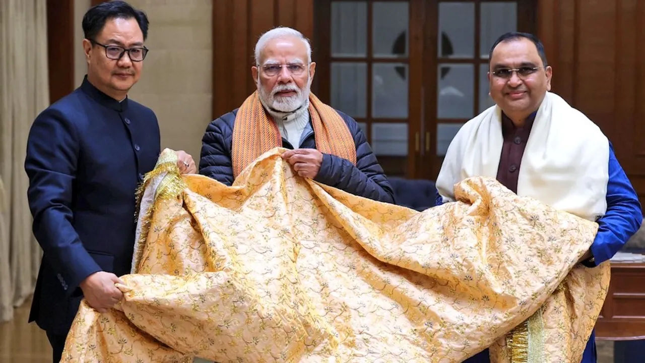 Narendra Modi presents the Chadar to Kiren Rijiju that would be offered on his behalf at the Ajmer Sharif Dargah on the Urs of Khwaja Moinuddin Chishti.