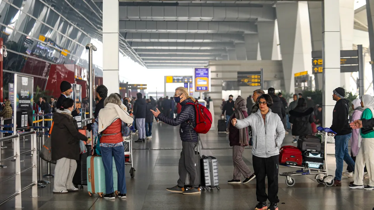 Passengers at Indira Gandhi International Airport during a cold and foggy winter morning, in New Delhi, Saturday, Jan. 4, 2025