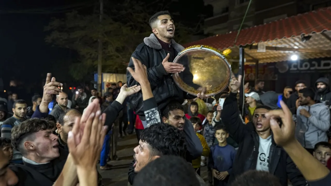 Palestinians celebrate the announcement of a ceasefire deal between Hamas and Israel in Dear al-Balah, central Gaza Strip, on Wednesday, Jan 15, 2024.