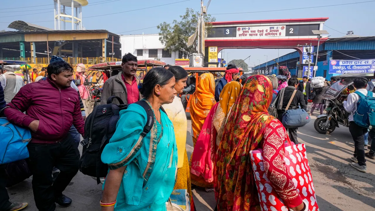 Commuters are seen outside Prayagraj Junction railway station during the ongoing Maha Kumbh Mela in Prayagraj on Friday, Jan. 31, 2025.