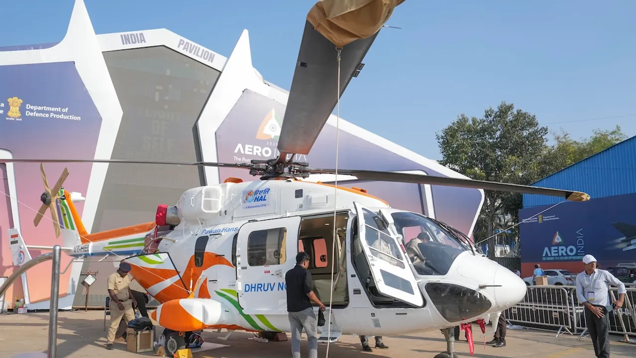 HAL staffers work on a Dhruv helicopter ahead of the Aero India 2025, at the Yelahanka Air Force Station in Bengaluru on Sunday, Feb. 9, 2025.