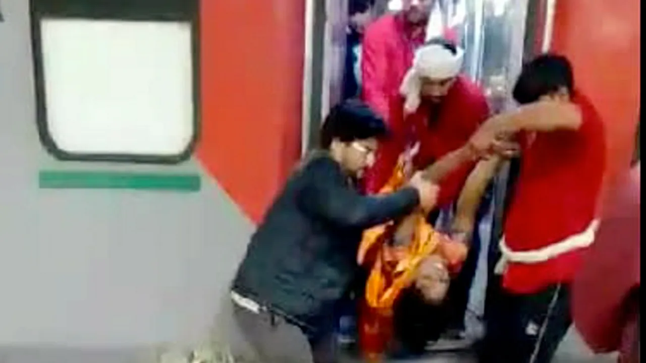 A woman, who fell unconscious, being taken on a trolly from a train, at the New Delhi railway station, Saturday, Feb. 15, 2025.