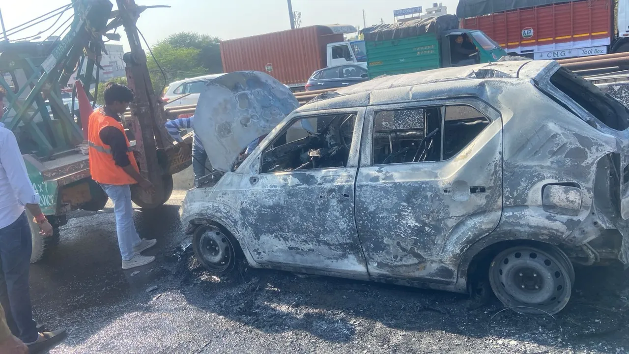 A car catches fire on Hero Honda Chowk flyover in Gurugram on Tuesday, Feb 18. 2025.