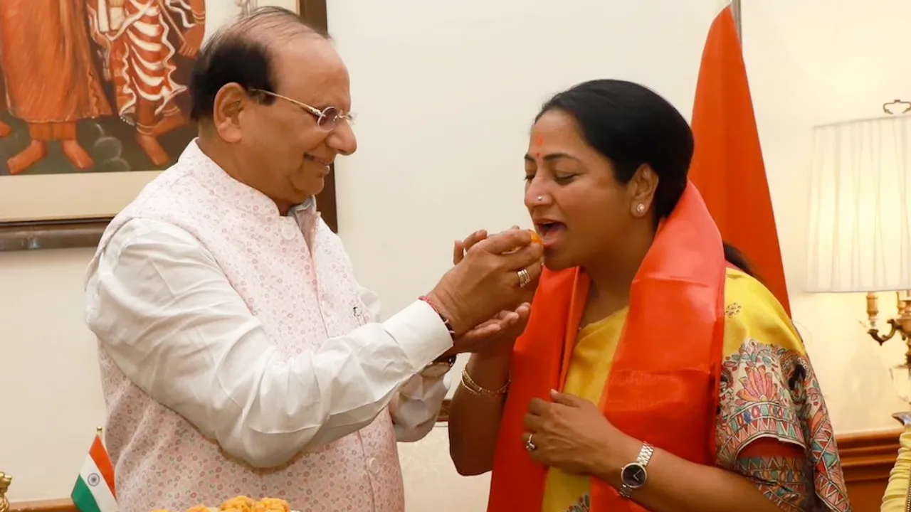 Delhi Lieutenant Governor V K Saxena offers sweets to BJP leader and Chief Minister-designate Rekha Gupta during a meeting at the Raj Niwas in New Delhi on Wednesday, Feb 19, 2025.