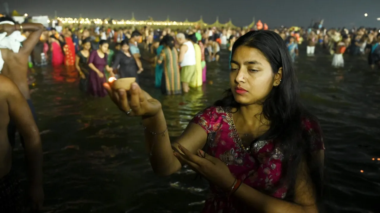 A woman devotee gets ‘tika’ on her forehead after taking a holy dip in the Ganga river on Maha Shivratri at Maha Kumbh in Prayagraj on Wednesday, Feb 26, 2025.