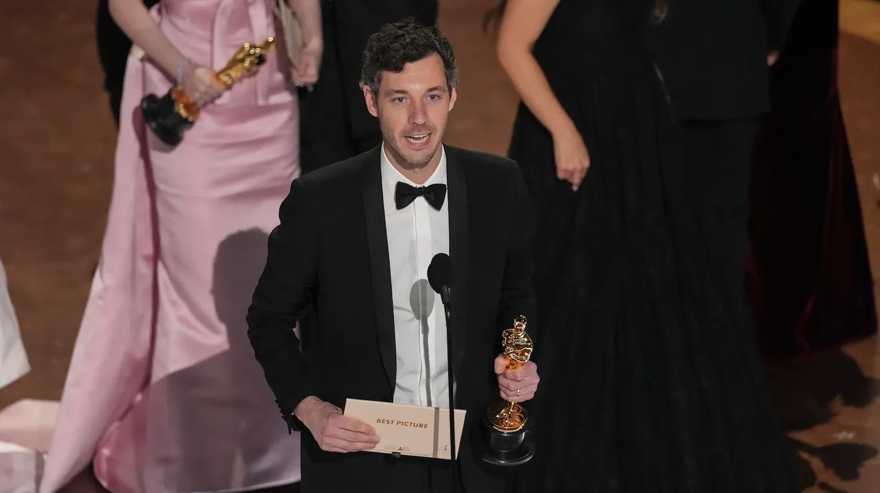 Alex Coco accepts the award for best picture for Anora during the Oscars on Sunday, March 2, 2025, at the Dolby Theatre in Los Angeles.