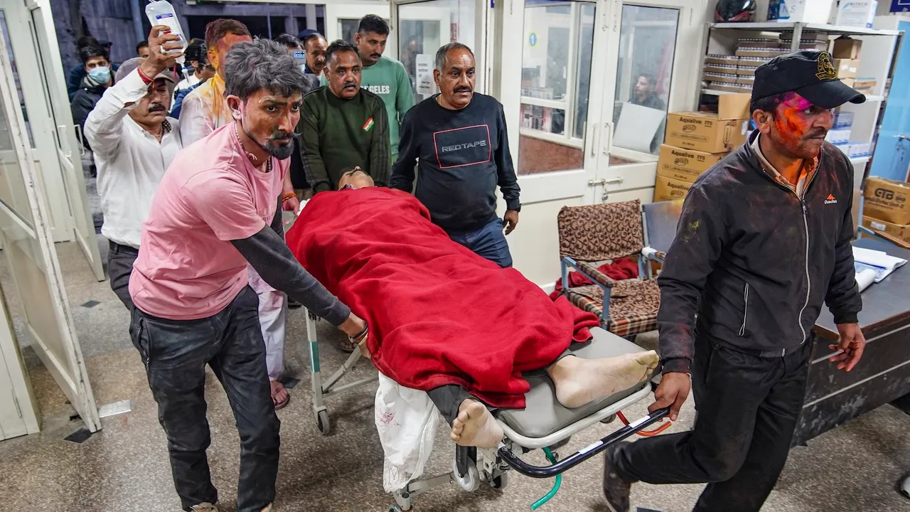 Bamber Thakur is being brought for treatment at a hospital after he was shot at by unidentified people at his residence in Shimla on Friday, March 14, 2025.