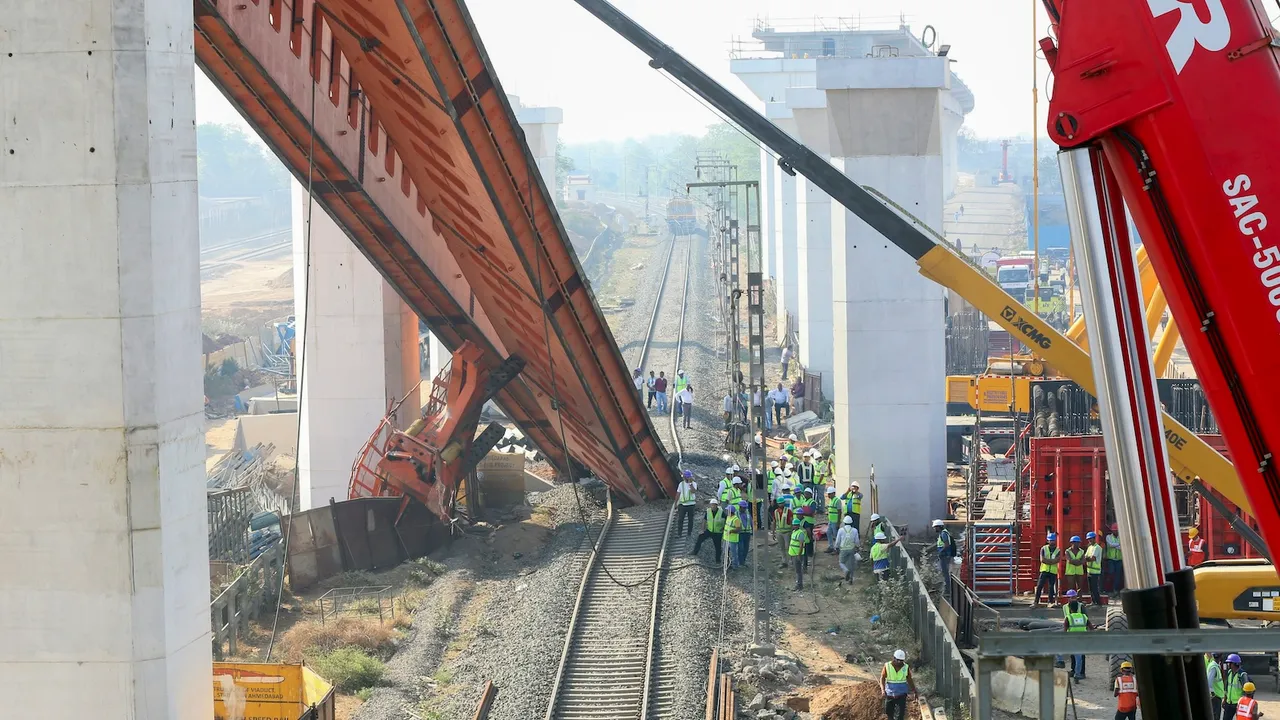 Restoration work underway after a segmental launching gantry (crane) skidded and fell near Vatva-Ropda Road, in Ahmedabad on Monday, March 24, 2025. 