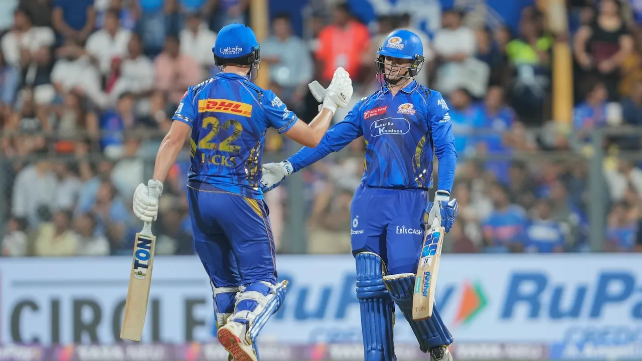 MI batter Ryan Rickelton celebrates his half century during the IPL 2025 cricket match between Mumbai Indians and Kolkata Knight Riders, in Mumbai, Monday, March 31, 2025.
