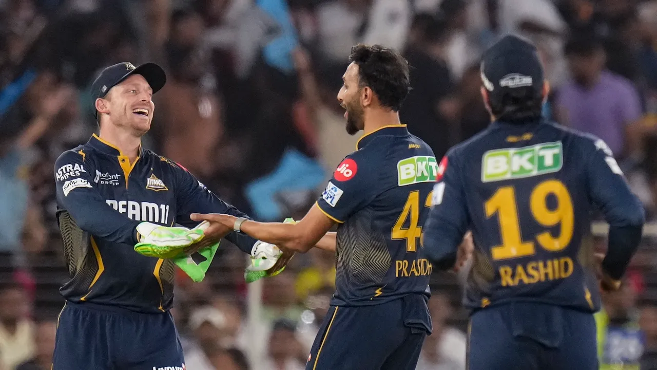 Gujarat Titans' Prasidh Krishna celebrates with Jos Buttler after taking the wicket of Rajasthan Royals’ captain Sanju Samson at the Narendra Modi Stadium in Ahmedabad on Wednesday, April 9, 2025.