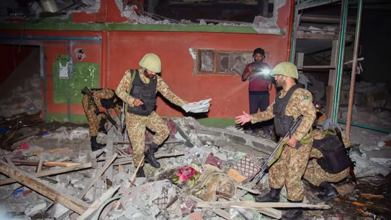 Pakistan Army soldiers examine a damaged building near Muzaffarabad, the capital of Pakistan-controlled Kashmir.