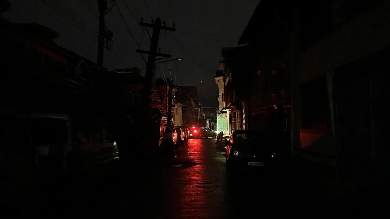 Vehicles stand parked on a road during blackout in view of the ongoing military conflict between India and Pakistan in Srinagar on Friday, May 9, 2025.