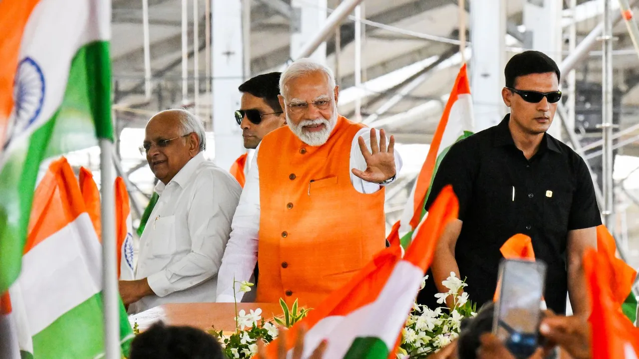 Narendra Modi with Gujarat Chief Minister Bhupendra Patel arrives at a public meeting, in Dahod, Gujarat.