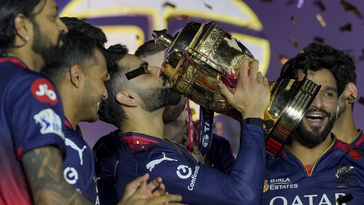 Virat Kohli kisses the IPL 2025 championship trophy at the Narendra Modi Stadium in Ahmedabad on Tuesday, June 3, 2025.