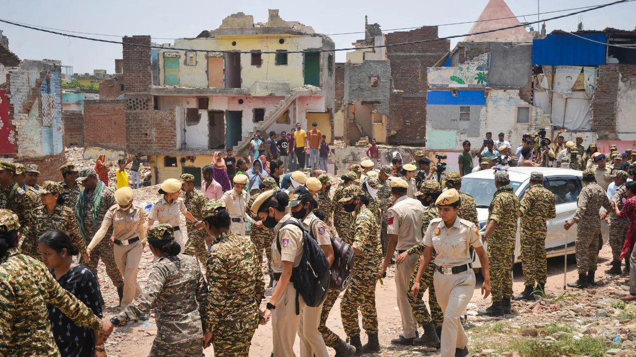 Security personnel deployed at the Bhoomiheen jhuggi-jhopri (JJ) camp, at Kalkaji, in New Delhi.