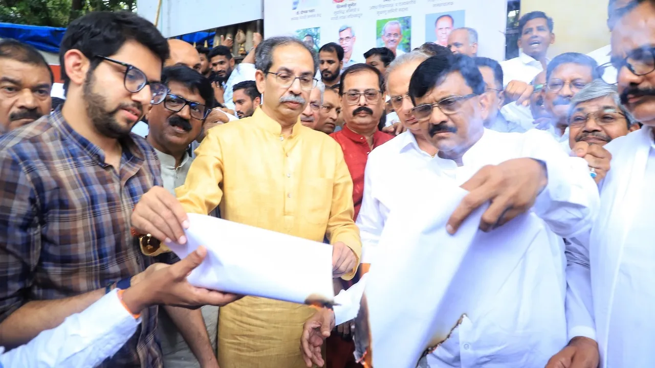 Uddhav Thackeray (centre) with son Aditya Thackeray and Sanjay Raut burning copies of the June 17 government resolution on the three language policy for schools in South Mumbai on Sunday, June 29, 2025.
