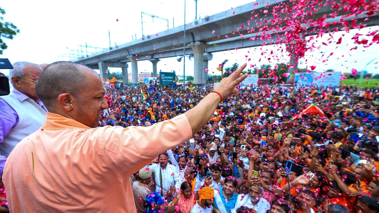 Yogi Adityanath showers flower petals on 'Kanwariyas' during their pilgrimage in the holy month of 'Shravan', in Meerut, Uttar Pradesh, Sunday, July 20, 2025.