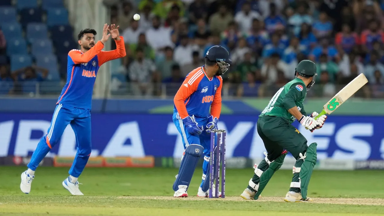 India's Axar Patel, left, fields the ball in the slips during the Asia Cup cricket match between India and Pakistan at Dubai International Cricket Stadium in Dubai, United Arab Emirates, Sunday, Sept. 14, 2025.