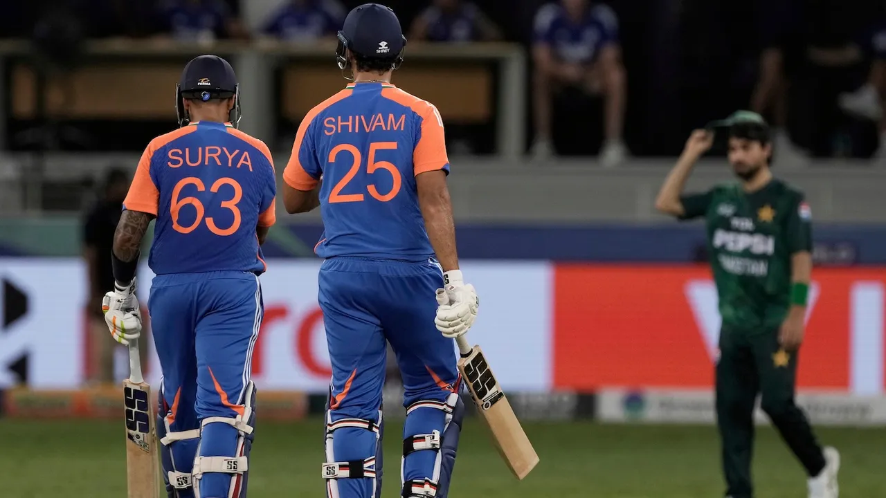 Suryakumar Yadav, left, and batting partner Shivam Dube leave the field after their win in the Asia Cup cricket match against Pakistan at Dubai International Cricket Stadium in Dubai, United Arab Emirates, Sunday, Sept. 14, 2025.