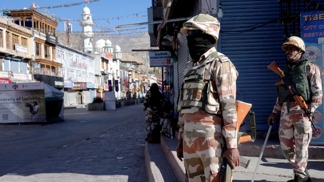 Security personnel stand guard on a street amid a curfew, in Leh, Ladakh, Saturday, Sept. 27, 2025.