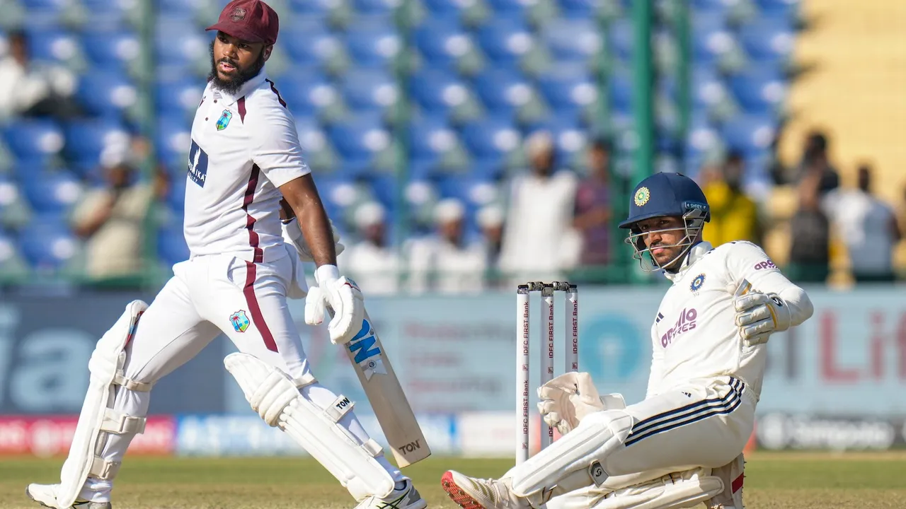 John Campbell, left, looks on after playing a shot on day three of the second and final Test cricket match of a series between India and West Indies, in New Delhi, Sunday, Oct. 12, 2025.