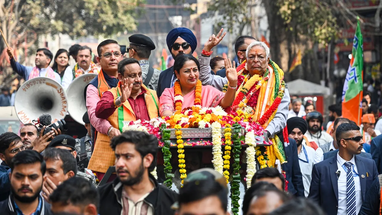 Delhi Chief Minister Rekha Gupta during a roadshow in support of BJP candidate from Chandni Chowk seat, Suman Kumar Gupta, right, ahead of the Municipal Corporation of Delhi (MCD) bypolls, in New Delhi, Friday, Nov. 28, 2025.