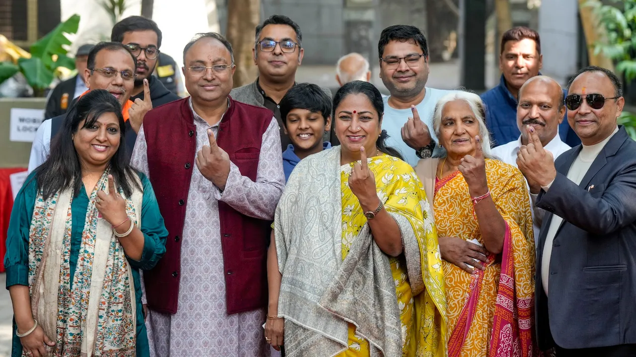 Rekha Gupta shows her ink-marked finger after casting her vote in the Municipal Corporation of Delhi (MCD) bypolls, at Shalimar Bagh in New Delhi, Sunday, Nov. 30, 2025.