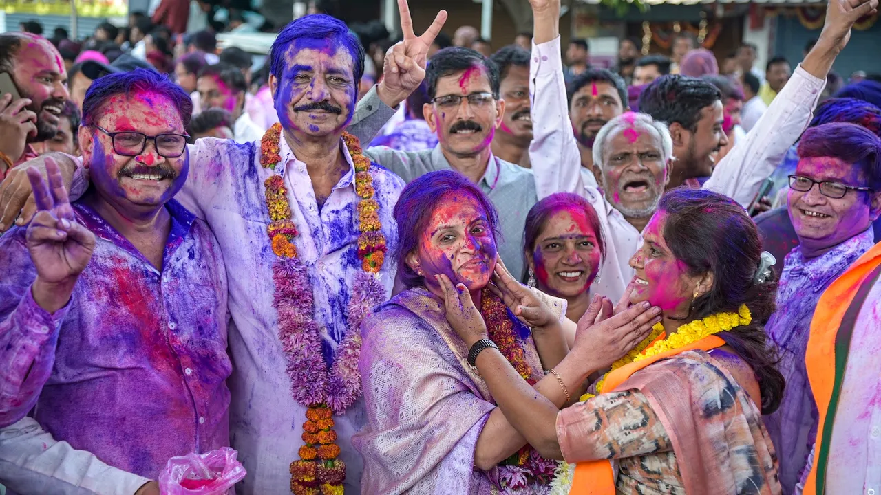 BJP candidate celebrates with supporters after winning the Maharashtra local body elections, following the declaration of results in Wadi rural area, near Nagpur, Maharashtra, Sunday, Dec. 21, 2025.