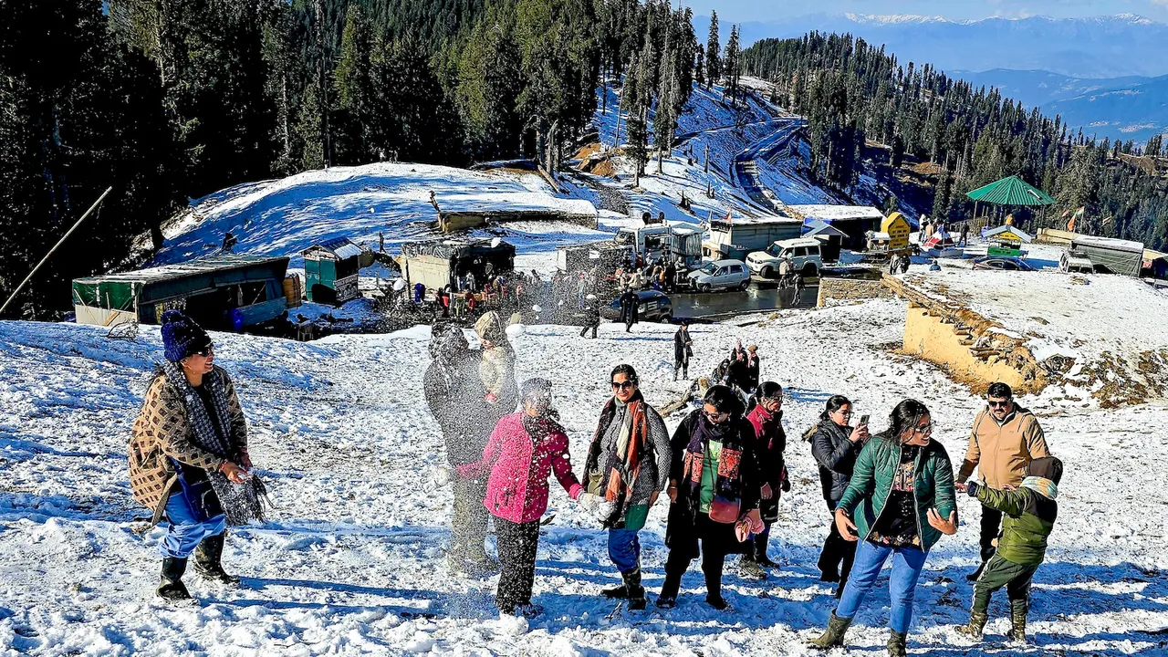 Visitors enjoy snowfall at Guldanda, near Bhaderwah, in Doda district of Jammu and Kashmir, Friday, Jan. 2, 2026.