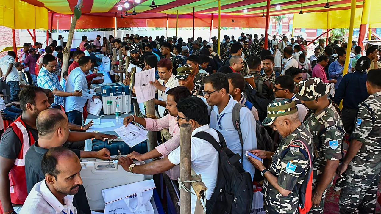 Polling officials collect EVMs and other election materials before leaving for the 5th phase of Lok Sabha elections, at a distribution centre, in Muzaffarpur, Sunday, May 19, 2024