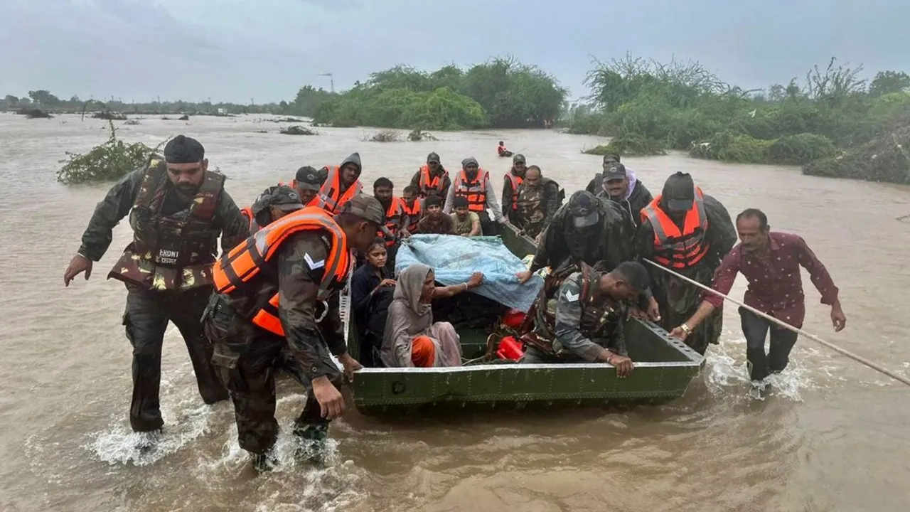 Army personnel during a rescue operation of stranded people following heavy rainfall, at flood-hit areas of Jamnagar, Rajkot and Dwarka
