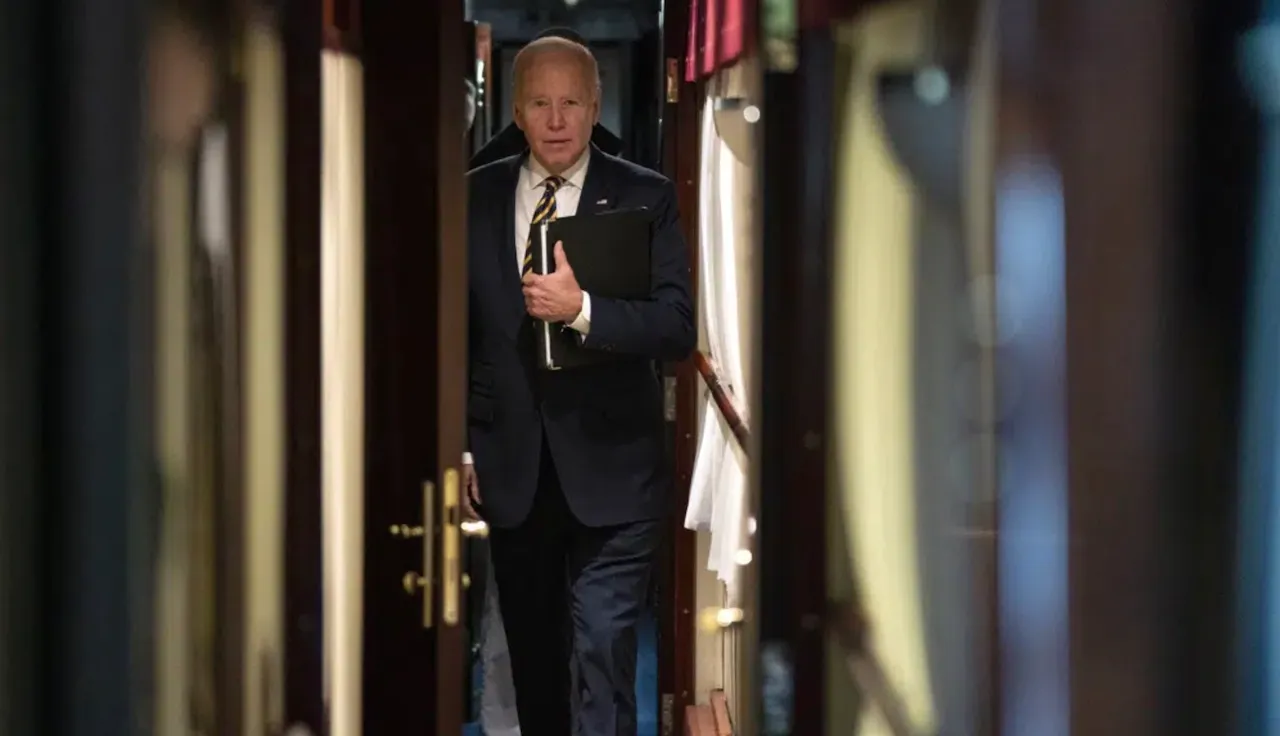 President Joe Biden walks down a corridor to his cabin on a train after a surprise visit with Ukrainian President Volodymyr Zelenskyy, Monday, Feb. 20 (AP)