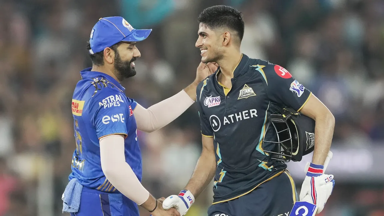 Gujarat Titans batter Shubman Gill celebrates his century as MI captain Rohit Sharma greets him during the IPL 2023 cricket playoff match between Gujarat Titans and Mumbai Indians at the Narendra Modi Stadium on May 26