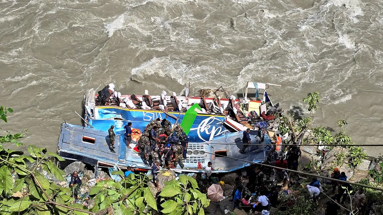 Security force personnel work to rescue injured passengers after a bus carrying Indian passengers traveling to Kathmandu from Pokhara plunged into a river in Tanahun District, Gandaki Province, Nepal