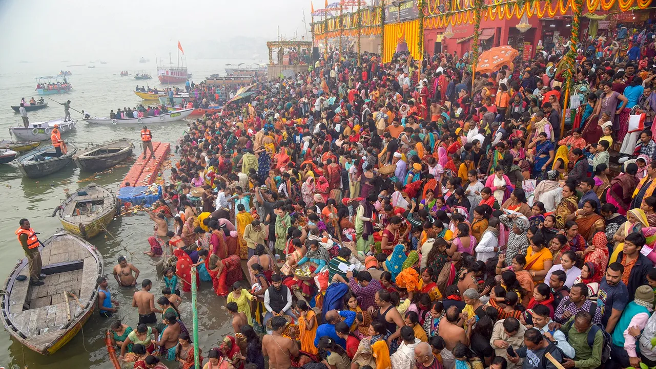 Devotees gather to take a holy dip in the Ganga river on Kartik Purnima fetival, at the Dashashwamedh Ghat in Varanasi