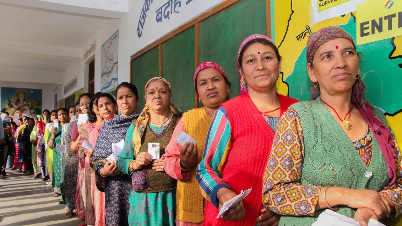 People wait at a polling booth to cast their votes during the seventh and last phase of Lok Sabha elections, in Kullu district, Himachal Pradesh, Saturday, June 1, 2024