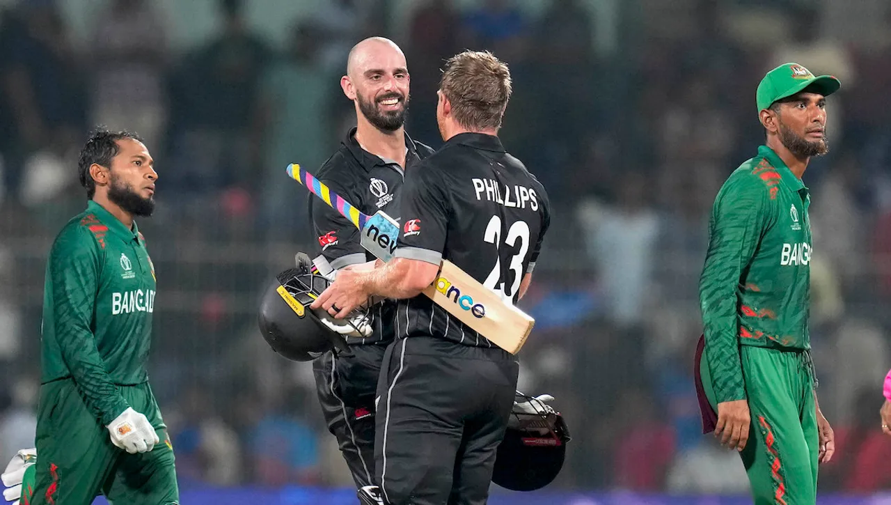 New Zealand's Daryl Mitchell and Glenn Phillips exchange greetings after scoring the winning runs in the ICC Men's Cricket World Cup 2023 match against Bangladesh, at M.A. Chidambaram Stadium, in Chennai, Friday, Oct. 13, 2023. 