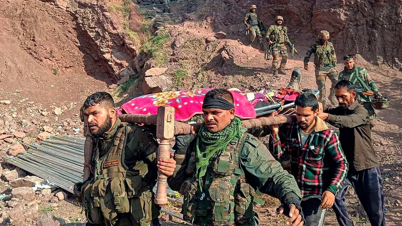 Army personnel and locals carry the body of an army officer near the site of an encounter with terrorists at Kalakote area, in Rajouri district