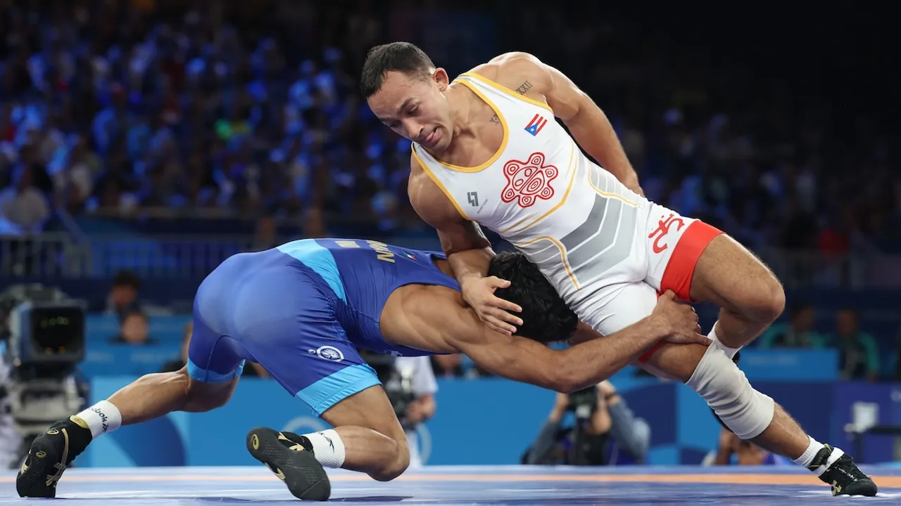 Darian Toi Cruz (red) of Puerto Rico and Aman Aman of India in action during their Men Freestyle 57kg Bronze Medal match of the Wrestling competitions in the Paris 2024 Olympic Games, at the Champs-de-Mars Arena in Paris, France, 09 August 2024.