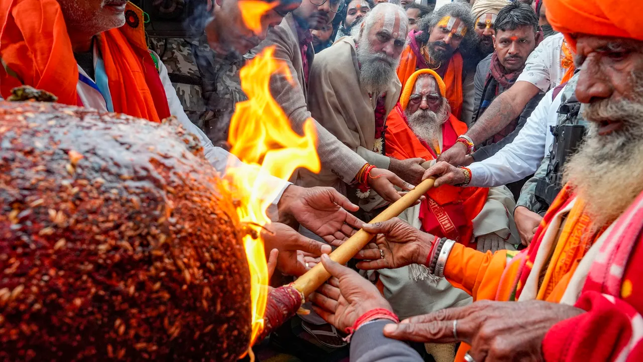 Mahant Nritya Gopal Das lights a 108-ft long incense stick (dhoop-batti) brought from Vadodara in Gujarat ahead of the Ram Mandir 'Pran Pratishthan' programme, in Ayodhya