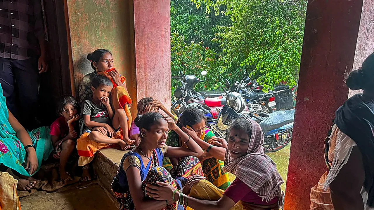 Family members of the people trapped under the rubble after a landslide at Irshalwadi village in Raigad district