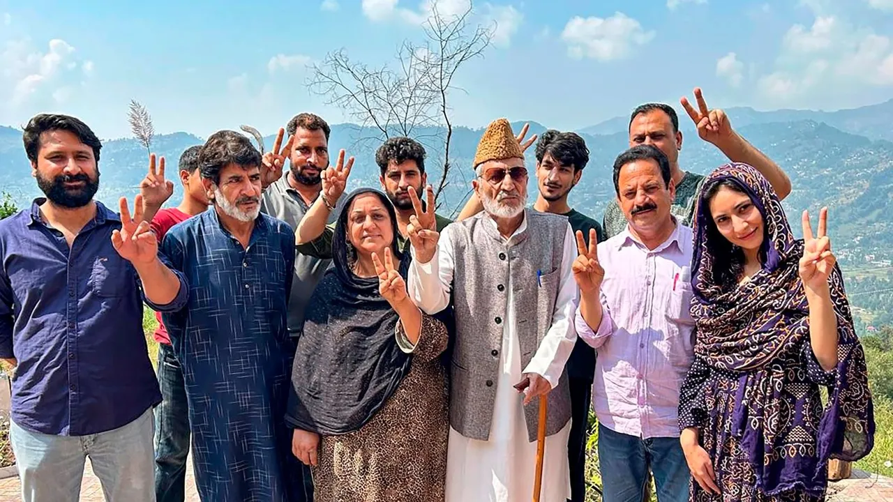 BJP candidate from Surankote constituency Syed Mushtaq Ahmad Bukhari poses for photos with others after casting vote during the second phase of Jammu and Kashmir Assembly elections.