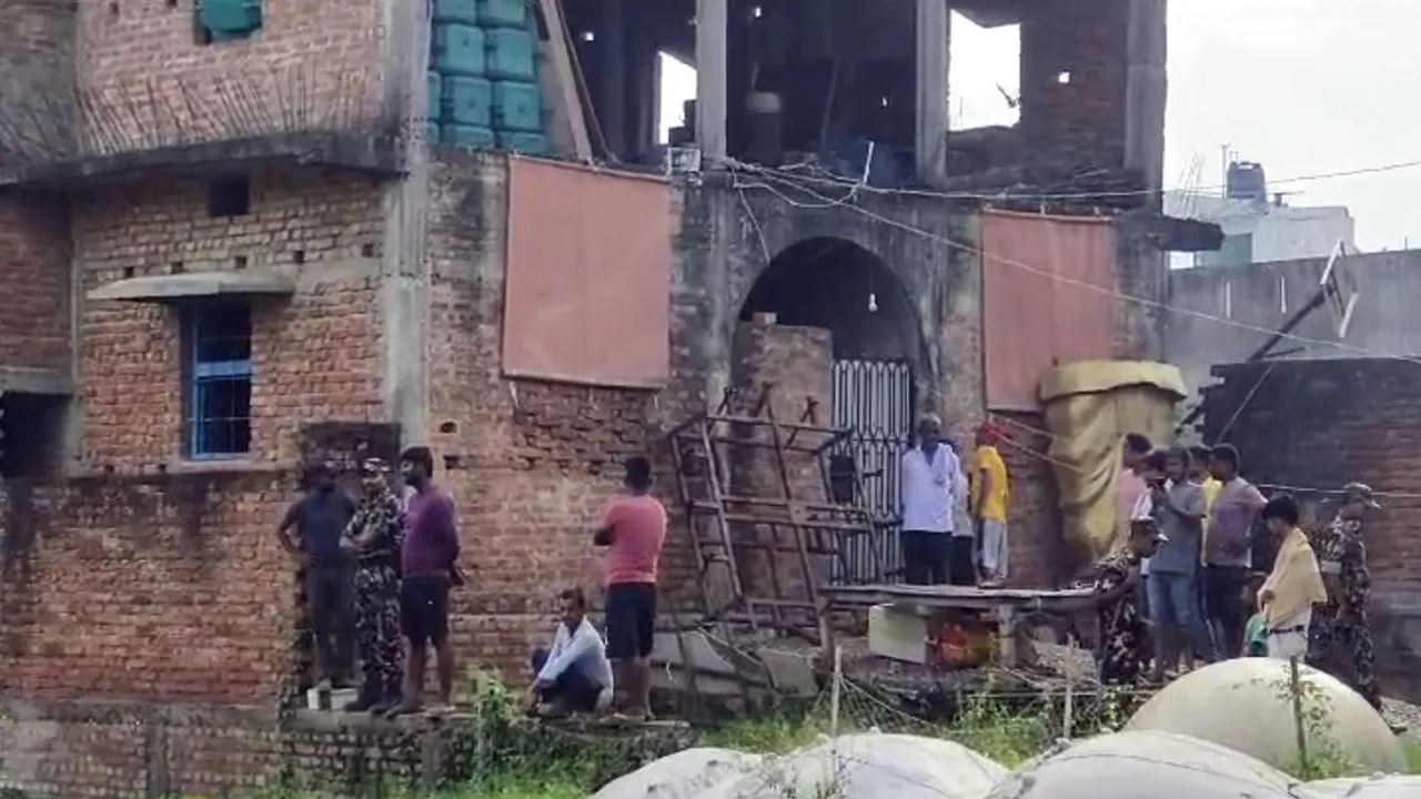 Security personnel and locals near the residence of Jitan Sahani, father of former minister Mukesh Sahani, after he was found dead, at Ghanshyampur in Darbhanga district, Tuesday, July 16, 2024.