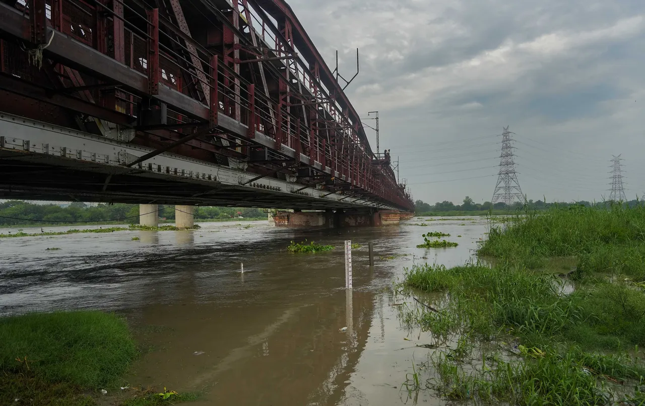 The Yamuna River swells up as its water level reaches near danger mark, at the Old Yamuna Bridge (Loha Pul), in New Delhi, Monday.jpg